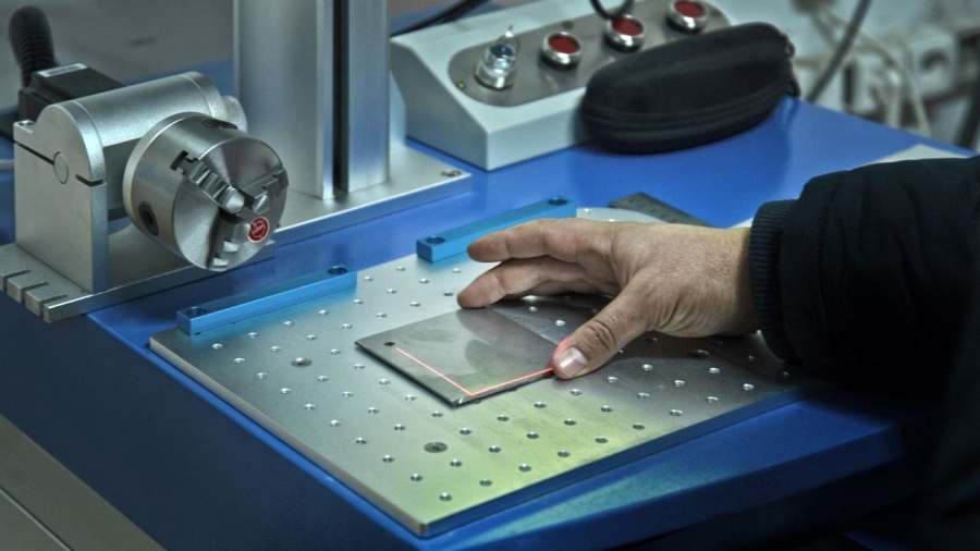 Precise hand control with laser technology in a laboratory setting, showcasing modern science.